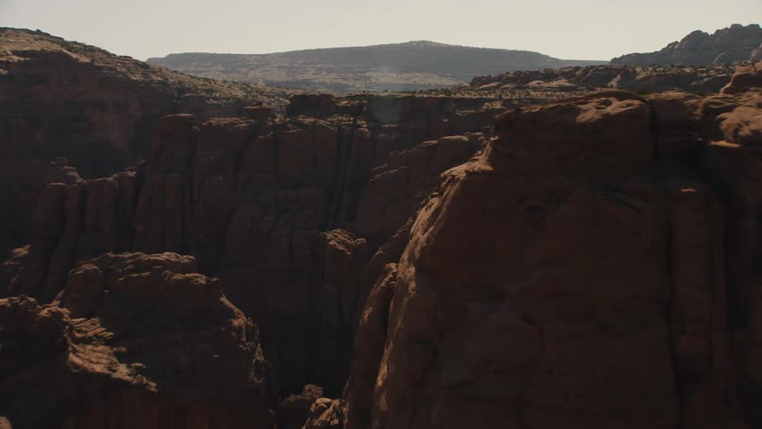 A canyon with the sky and clouds in the background