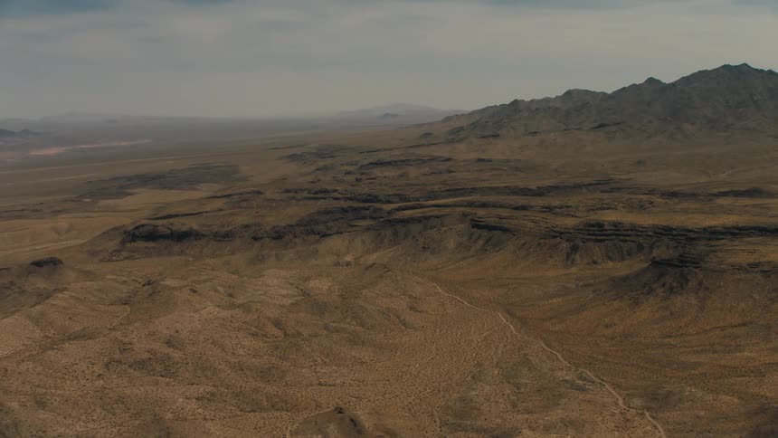 The mountains in the distance are covered with fog