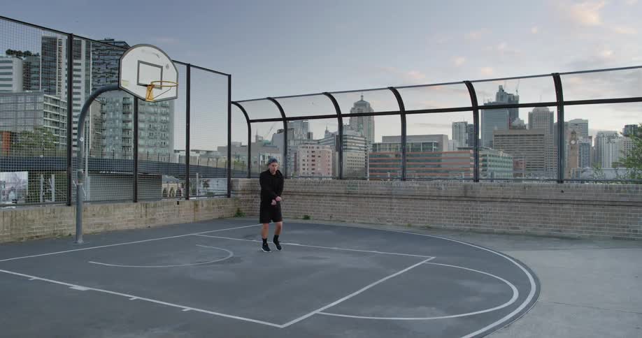 A man is jumping rope on the roof top court