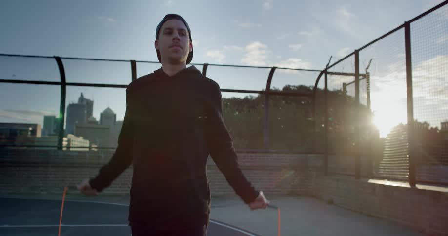 A man is jumping rope in the court