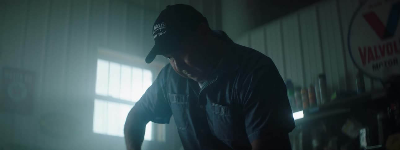 Man wearing a hat works in his garage