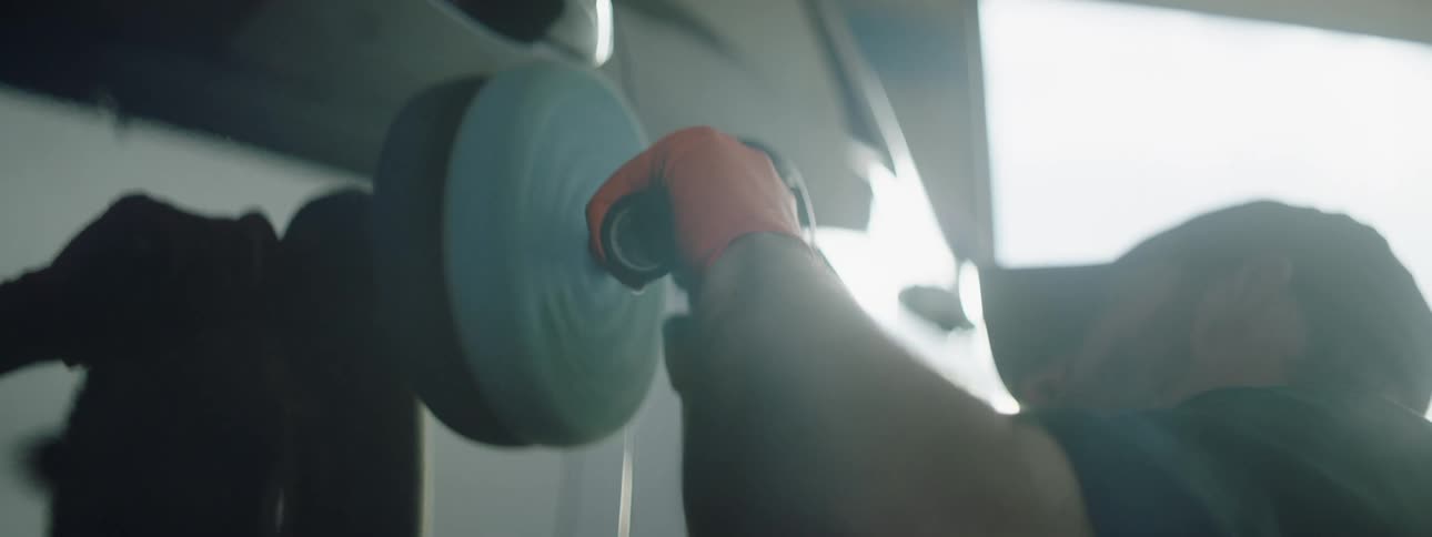A man polishing a car