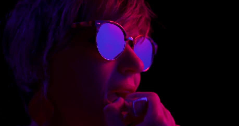 A young woman putting lipstick on