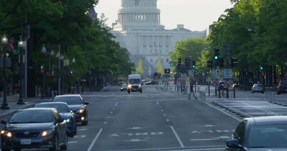 A city street with the united states capitol building in the background