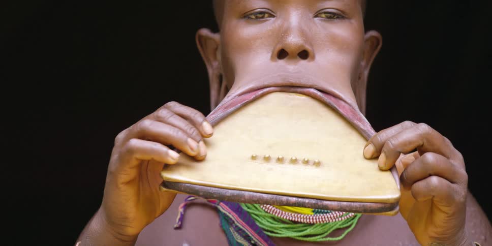 A woman wraps her lip around a large plate