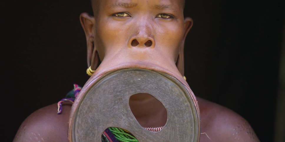 Close up of a woman wearing a large lip plate