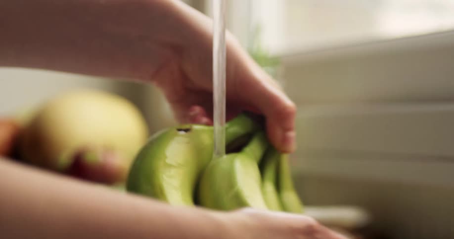 Rinsing off bananas in the kitchen sink
