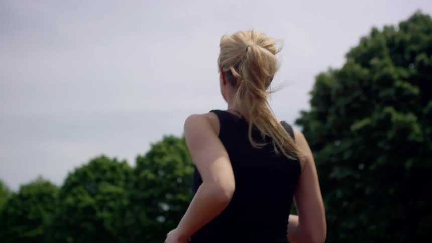 Woman jogging in a park in slow motion