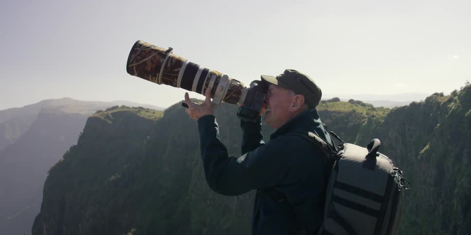 A man takes pictures with a large camera