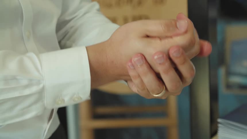 A man is using hand sanitizer
