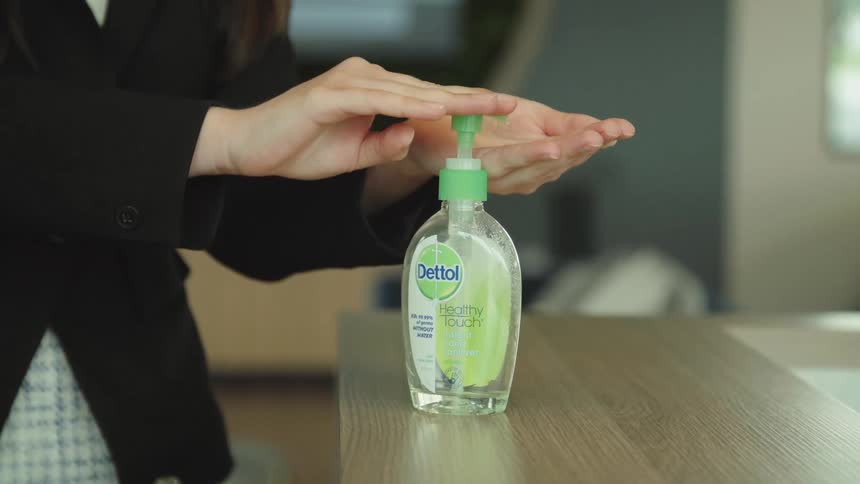 Putting on hand sanitizer from a pump bottle