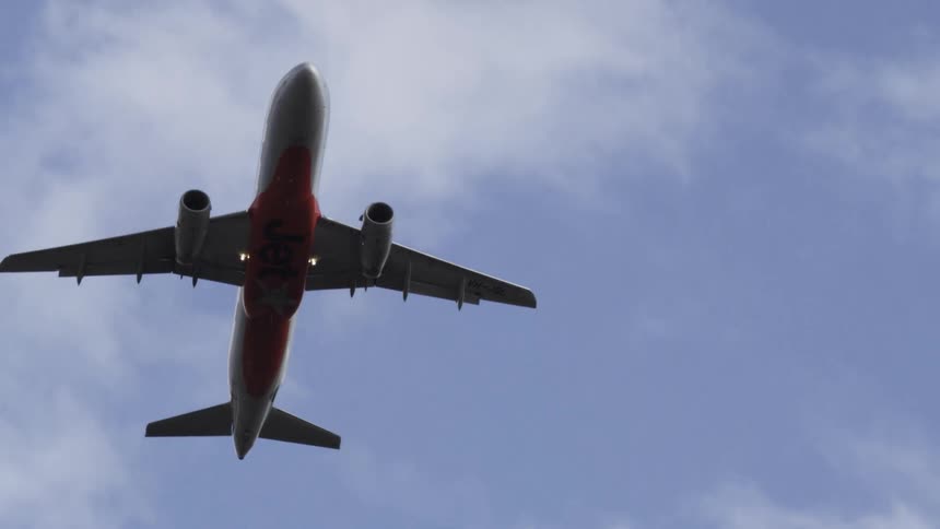 The plane flies overhead