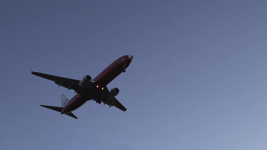 The large plane glides in the sky