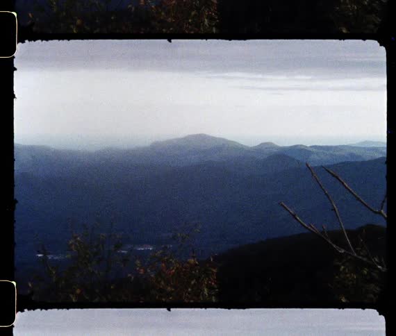 Lake sits with the mountains in the distance
