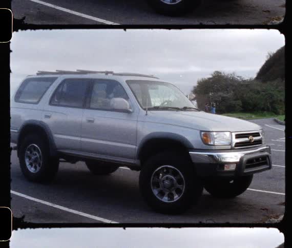 Vintage footage of sports utility vehicle parked in a parking lot