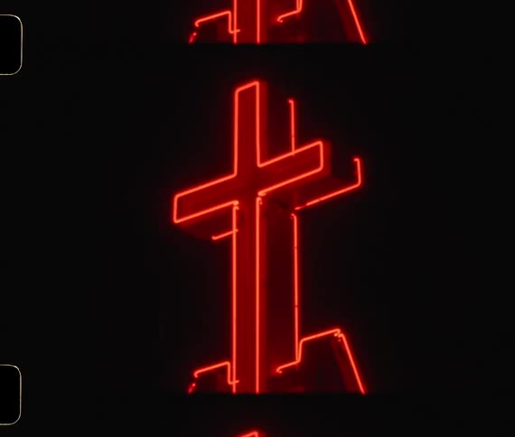 Cross lit with neon lights at night