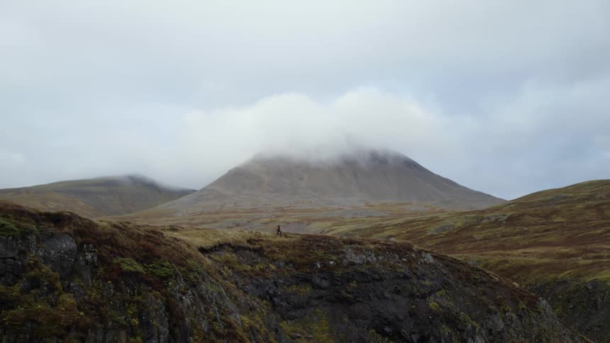 A person is hiking on the mountain top