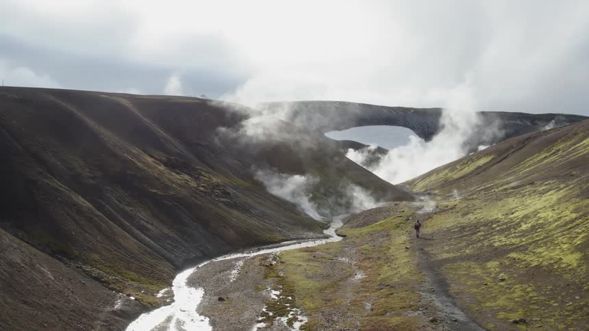 The icy stream is melting giving off steam
