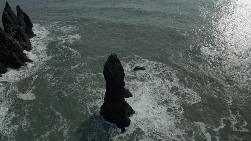 Large rock formations are in the ocean