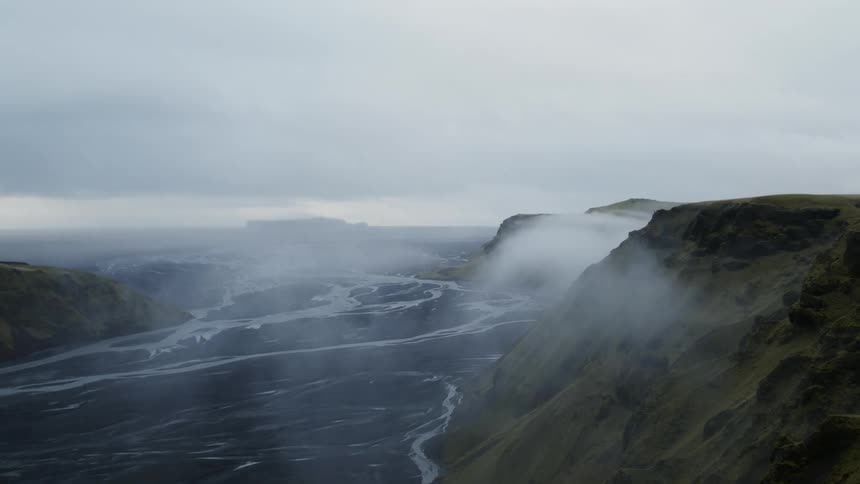 Aerial view of hills and a valley with a river running through it