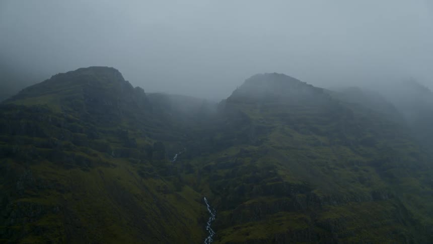 Fog obscures forest covered mountains and river
