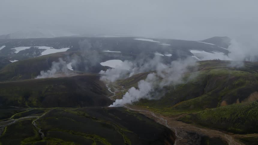 Steam rises from areas of the mountain range