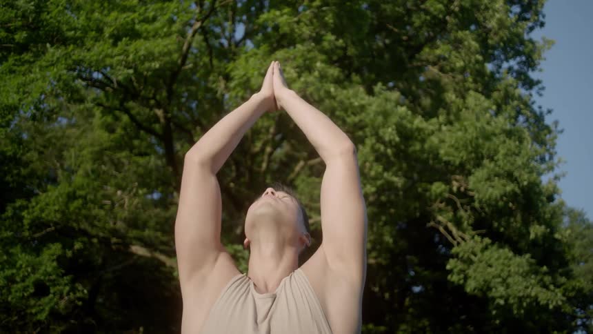 A teenager practices yoga outside
