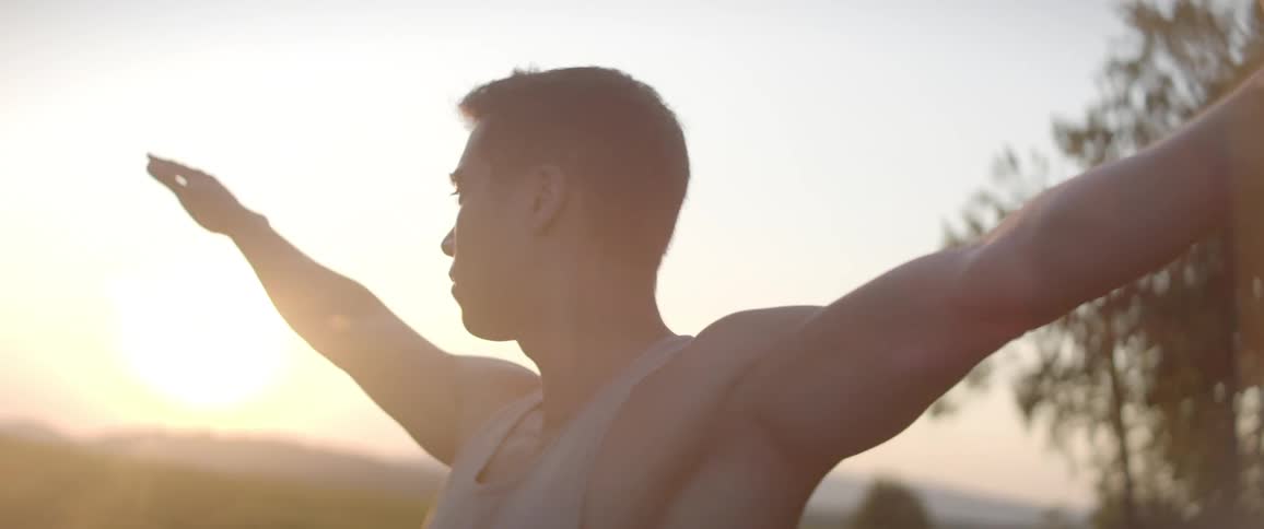 A man is doing a yoga pose outdoors