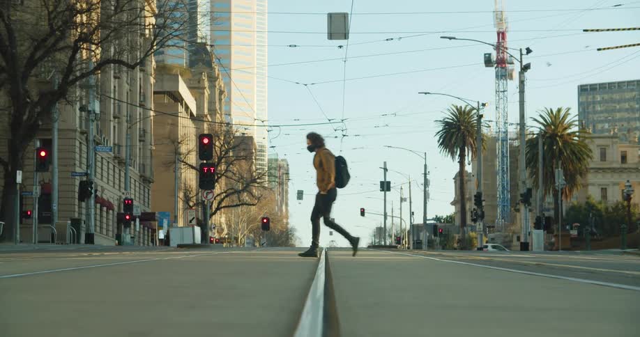 A man crosses the street in the city