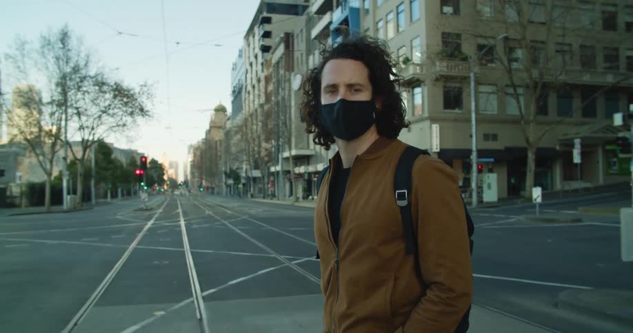 A man crosses the empty city street