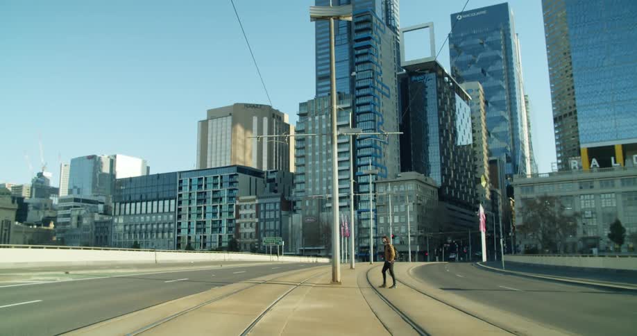 A pedestrian is walking in a downtown city