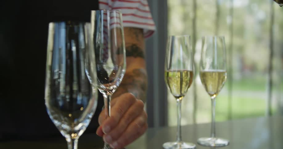 A man fills a champagne glass