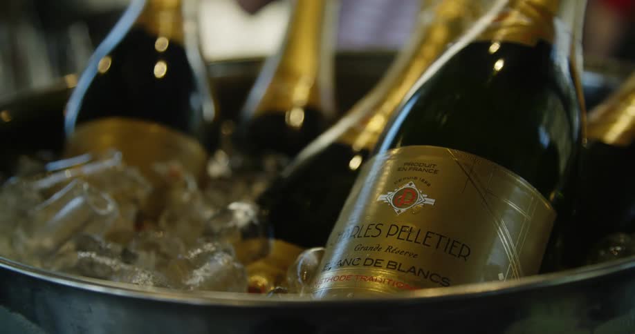 Wine bottles are chilled in ice filled metal bucket
