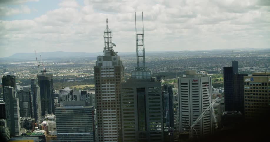 Skyscrapers in a metropolis under a sky filled with white clouds