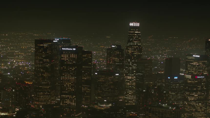 Skyline of the illuminated city with skyscrapers and tall buildings at night