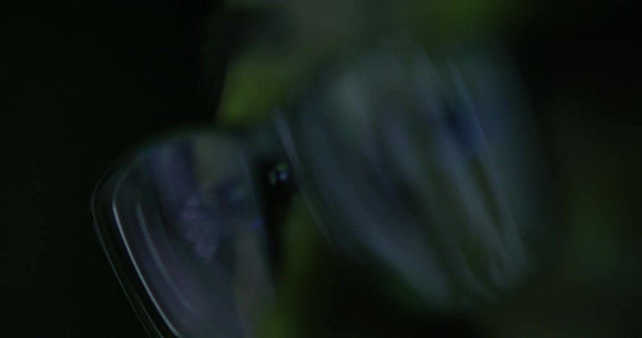An abstract footage of eye glasses reflection in the dark