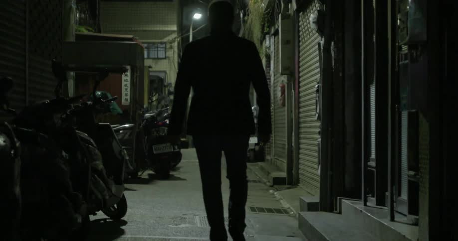 A man walking down an alley