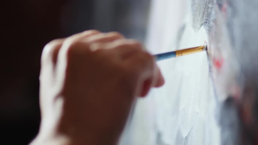 A painter painting on the canvasa