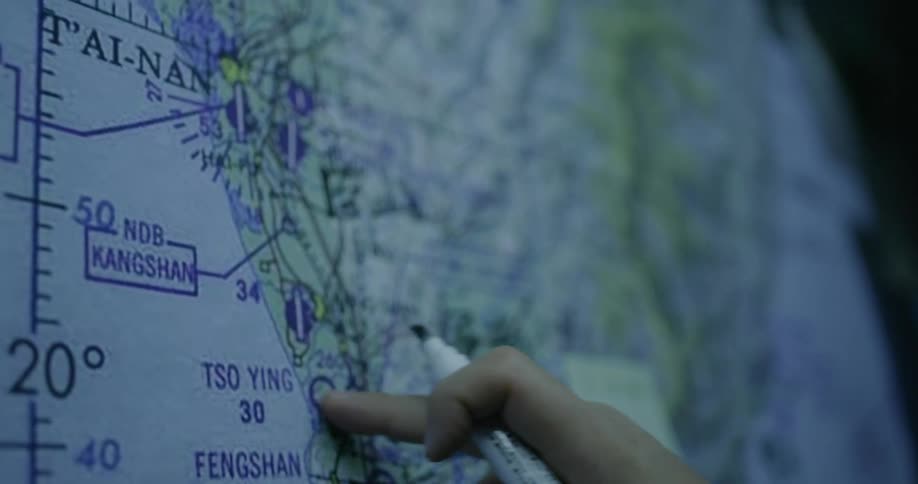 Finger touching a map on a board and hold a marker