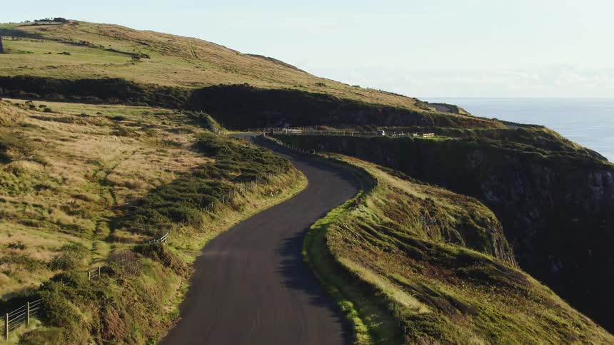 Road goes through the mountains near the ocean