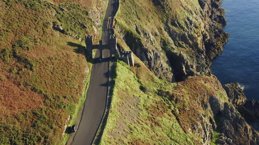 A gate stops access to homes along a cliff in the countryside