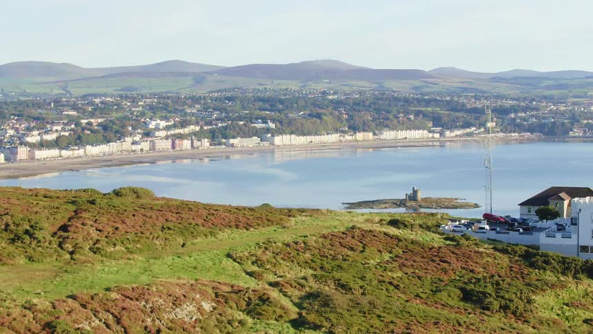 Aerial view of a small waterfront city in the hills near the ocean