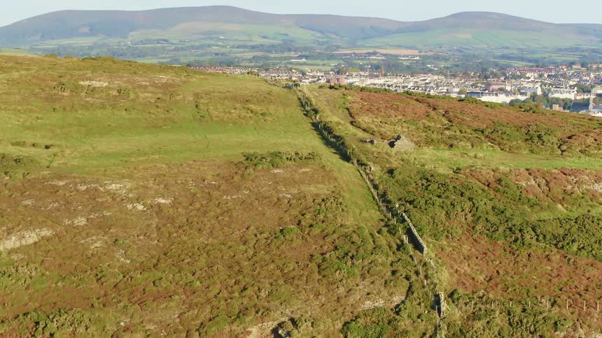 Country meets city with a castle and vast land overlooking a dense city below