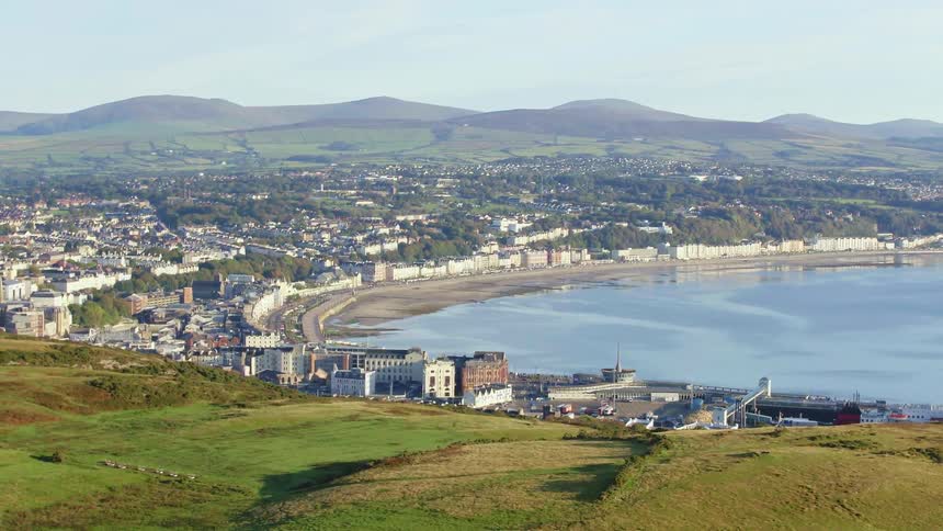 Aerial view of a small coastal town in the hills