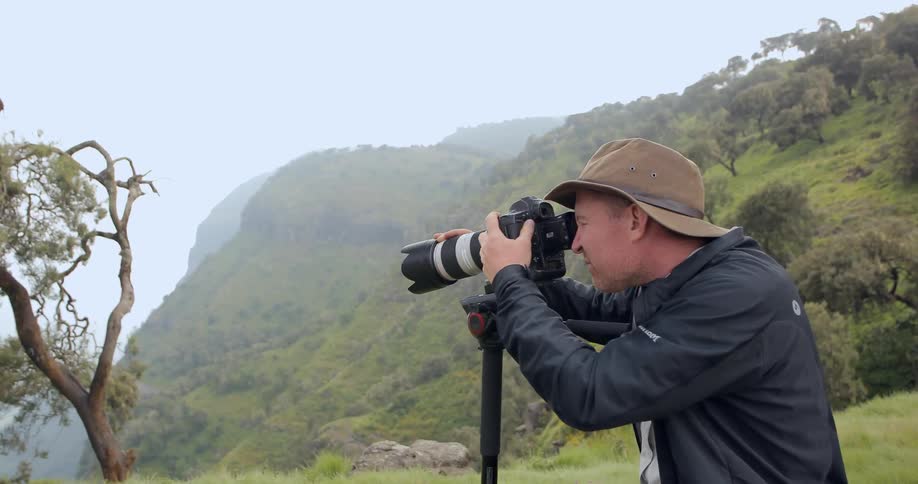A man photographing another photographer in nature