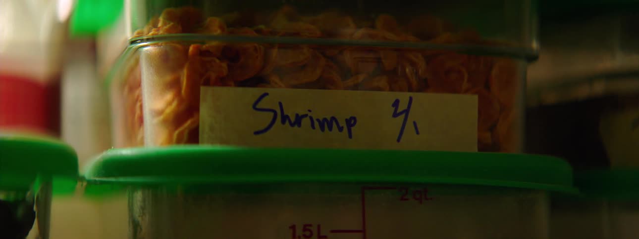 Shrimp stored in a labeled clear plastic container