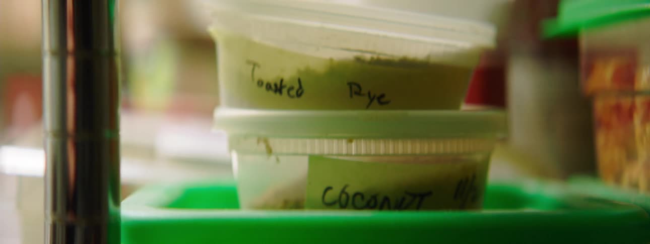 A stack of labeled plastic food containers