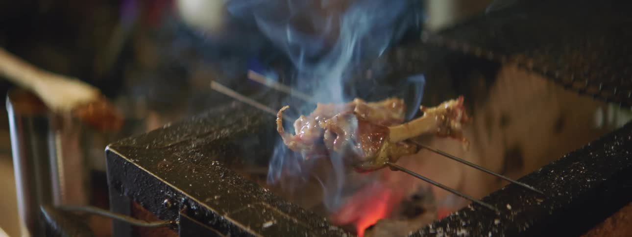 Chicken bones cook over an open grill