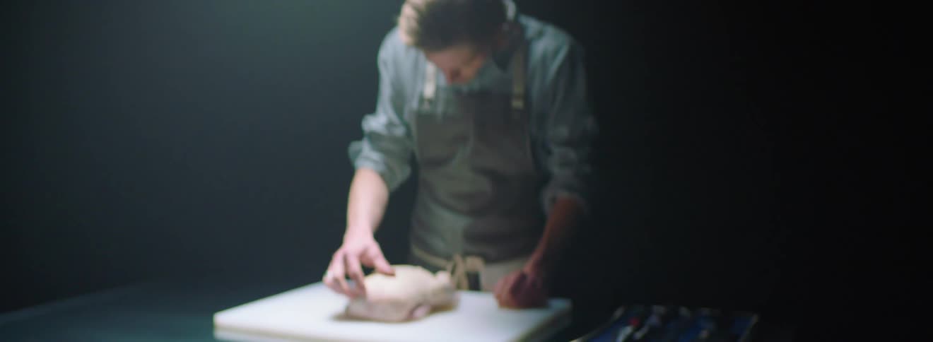 Man examines poultry carcass