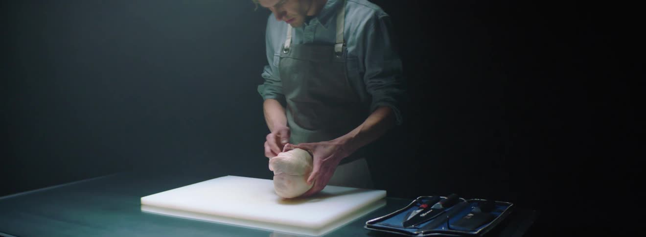 Man examines whole poultry